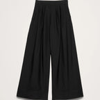 Black wide-leg pants on a light gray background