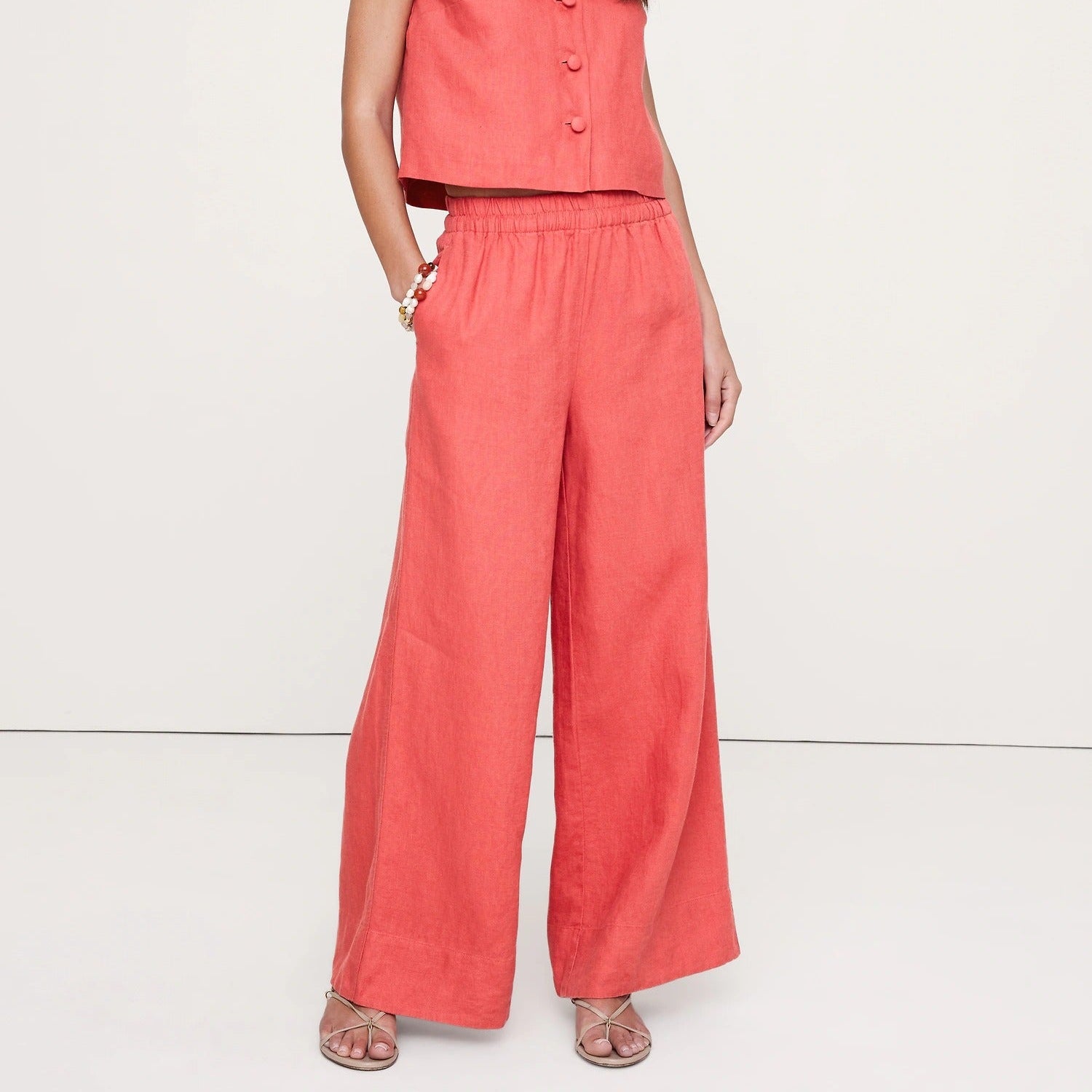 Coral colored wide leg trousers with an elasticated waist