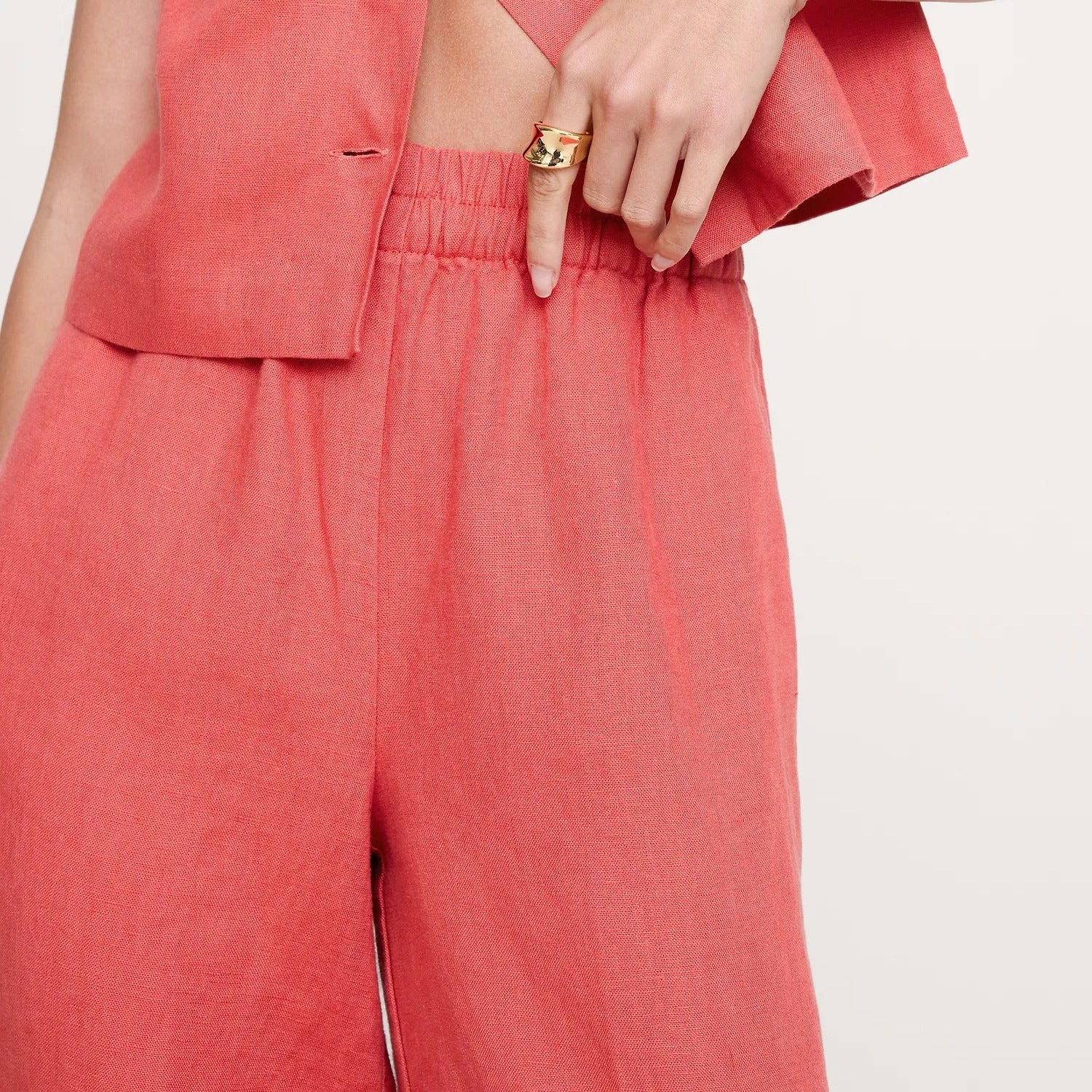 Coral colored wide leg trousers with an elasticated waist