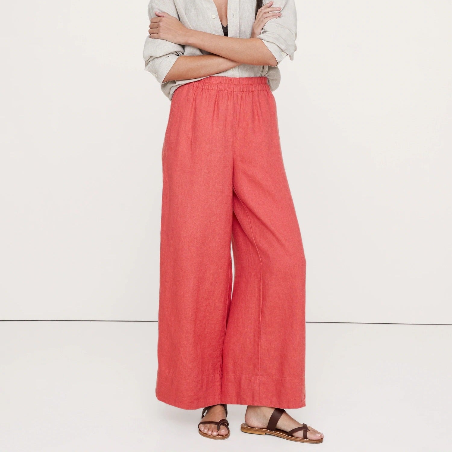 Coral colored wide leg trousers with an elasticated waist