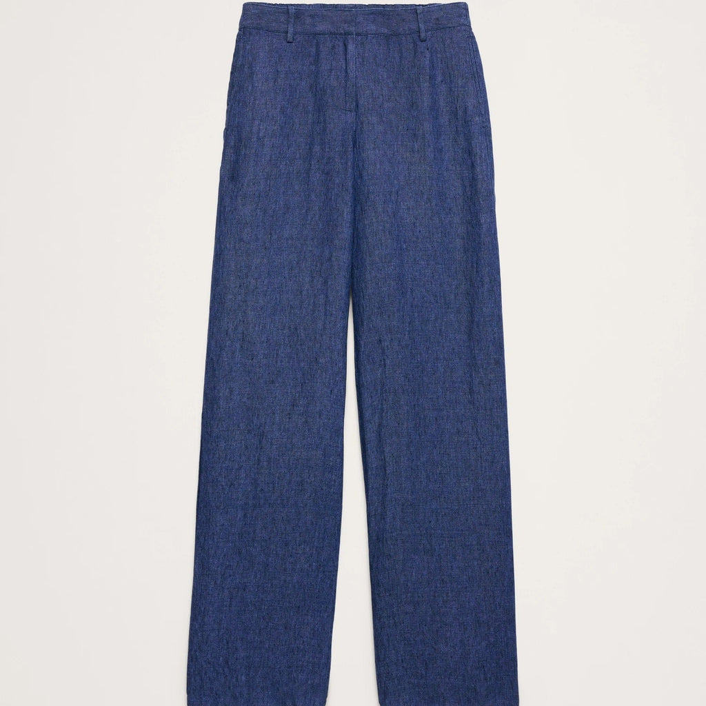 A pair of blue wide-leg trousers with a textured, slightly heathered fabric, shown flat against a light off-white background.