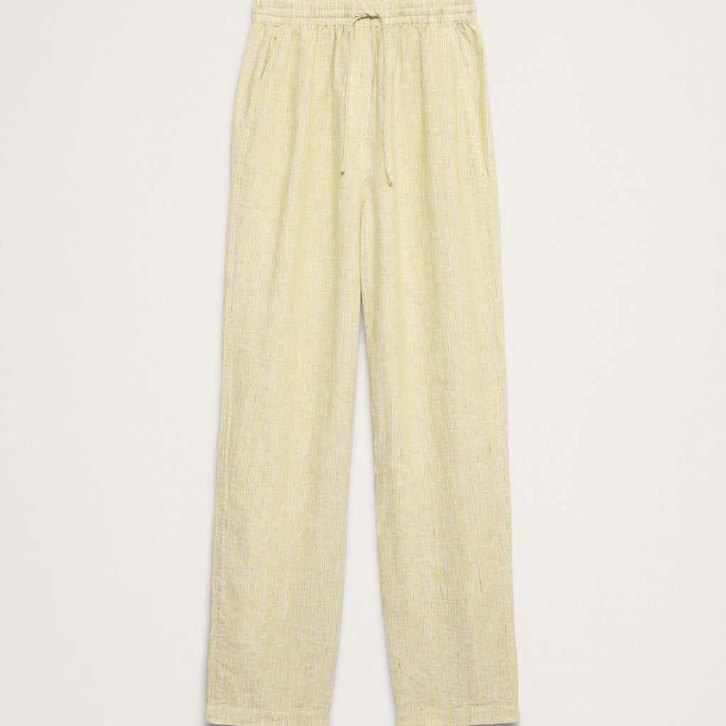 Light yellow linen trousers with an elastic waistband and drawstring, shown flat on a light beige background.